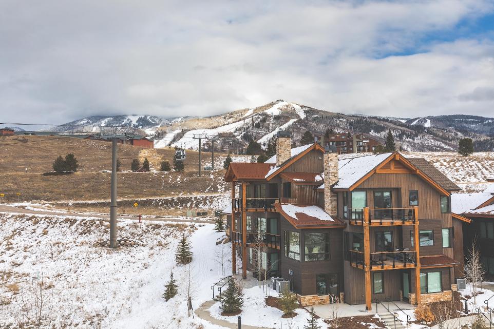 brown and white wooden house on snow covered ground during daytime